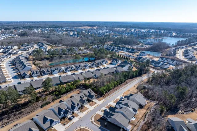 a view of a house with swimming pool and sitting area