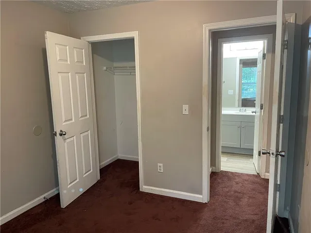 an empty room with closet area