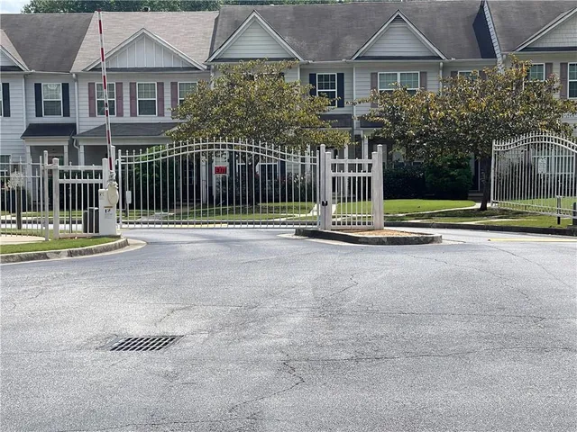 a front view of a house with a garden and plants