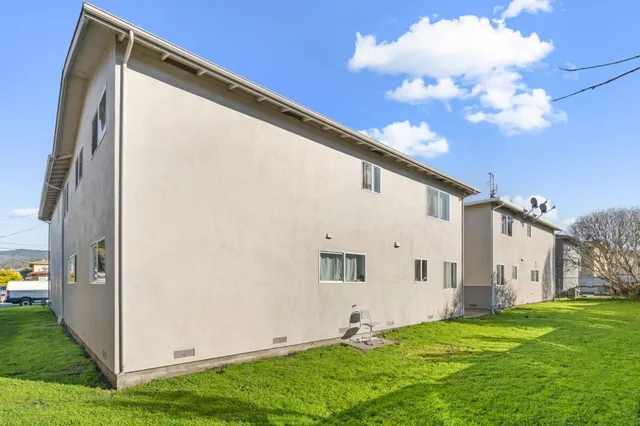 a view of a back yard of the house with a yard