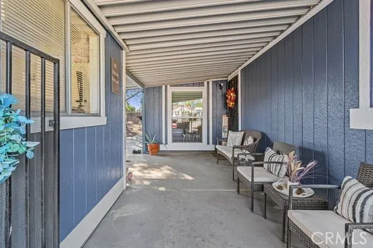 a view of a porch with furniture and next to a yard