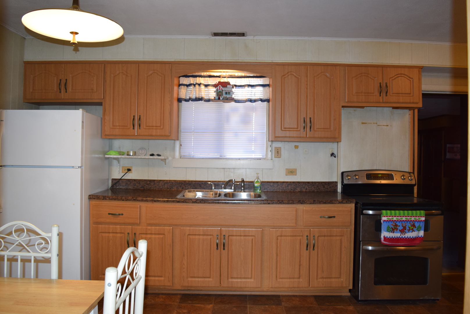 2112 Hawthorne Road Homewood, IL 60430 - Photo 8 of 13 a kitchen with granite countertop a refrigerator a stove a sink and white cabinets with wooden floor