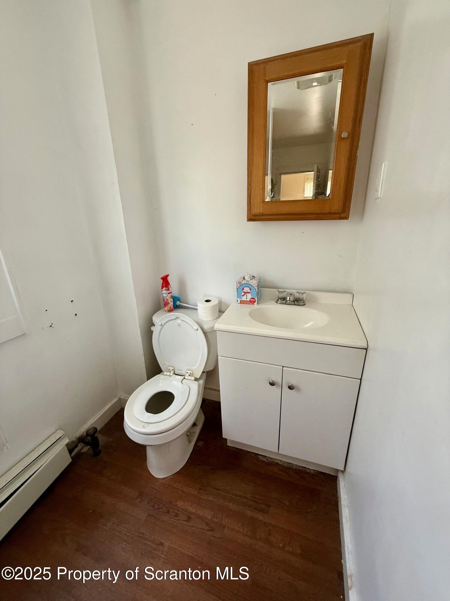 97 Washington Street Carbondale, PA 18407 - Photo 16 of 18 a bathroom with a toilet sink and mirror
