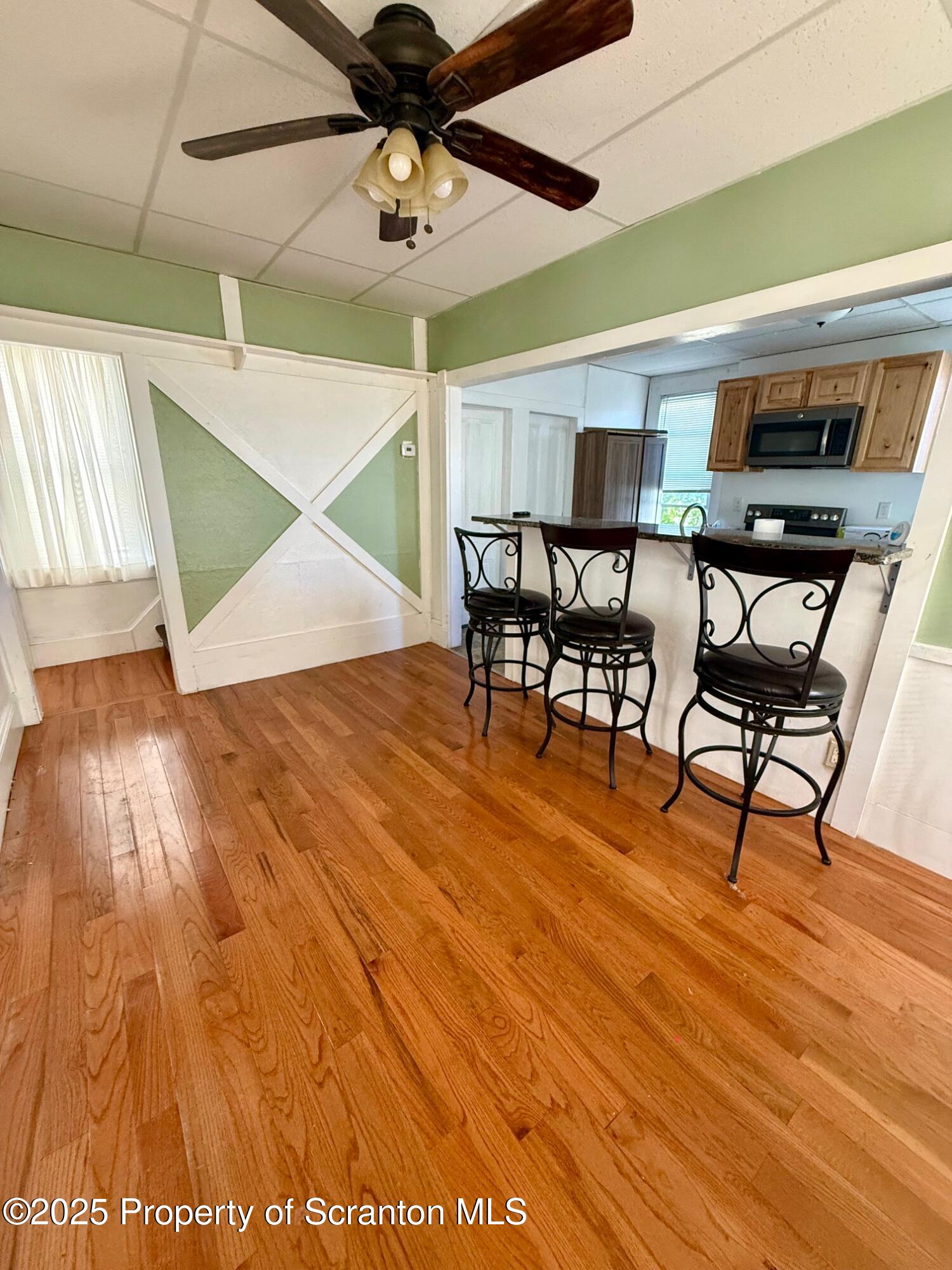 97 Washington Street Carbondale, PA 18407 - Photo 6 of 18 a view of a room with furniture and wooden floor