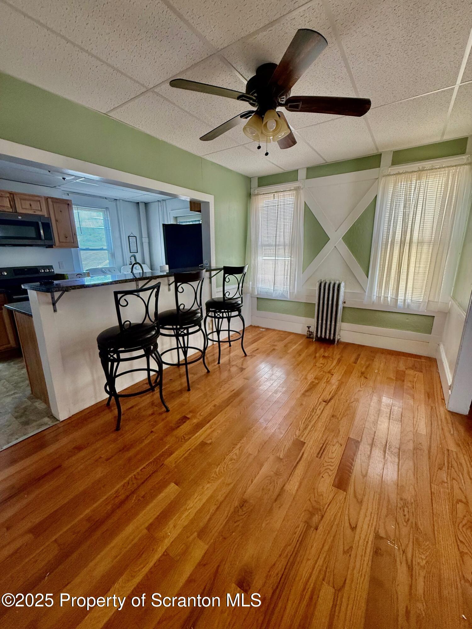97 Washington Street Carbondale, PA 18407 - Photo 7 of 18 a living room with furniture and a wooden floor