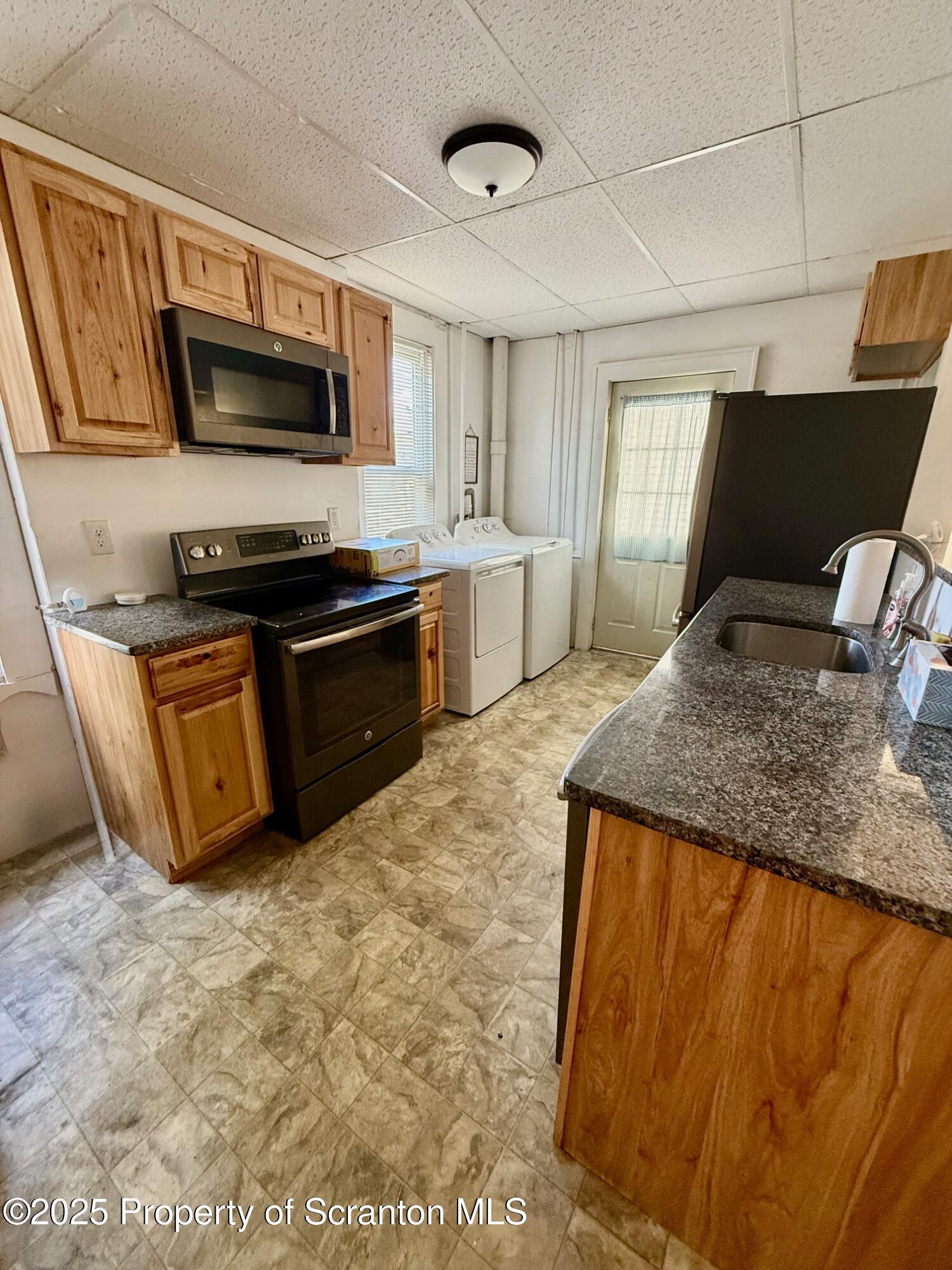 97 Washington Street Carbondale, PA 18407 - Photo 8 of 18 a kitchen with stainless steel appliances granite countertop a sink and a stove