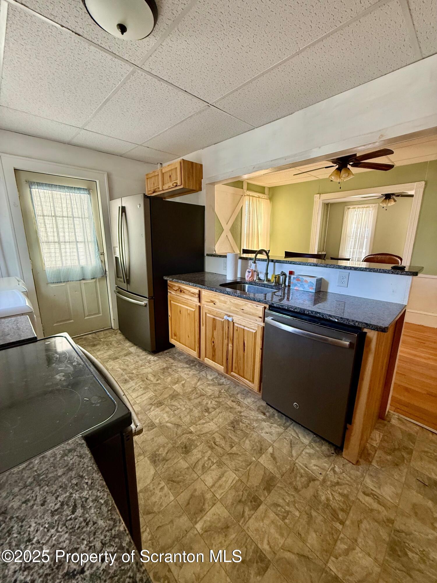 97 Washington Street Carbondale, PA 18407 - Photo 9 of 18 a kitchen with stainless steel appliances granite countertop a stove a sink and a microwave