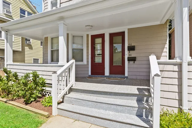 a front view of a house with a garden