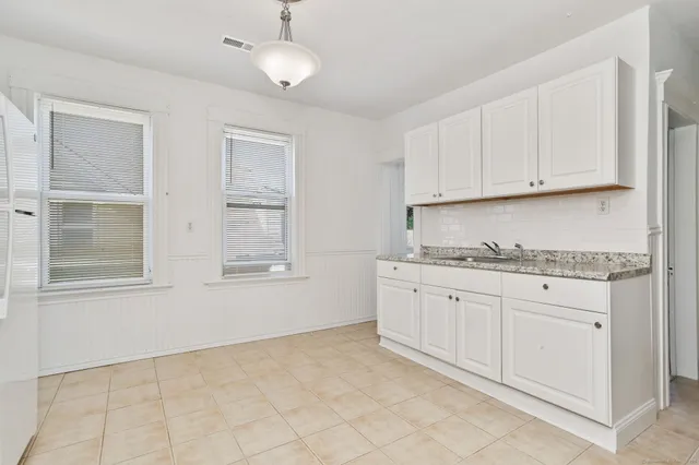 a kitchen with granite countertop cabinets and window