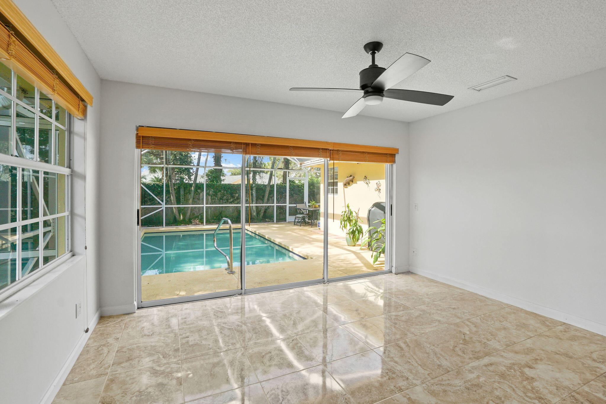 198 Brier Circle Jupiter, FL 33458 - Photo 12 of 38 a view of an empty room and a window and balcony