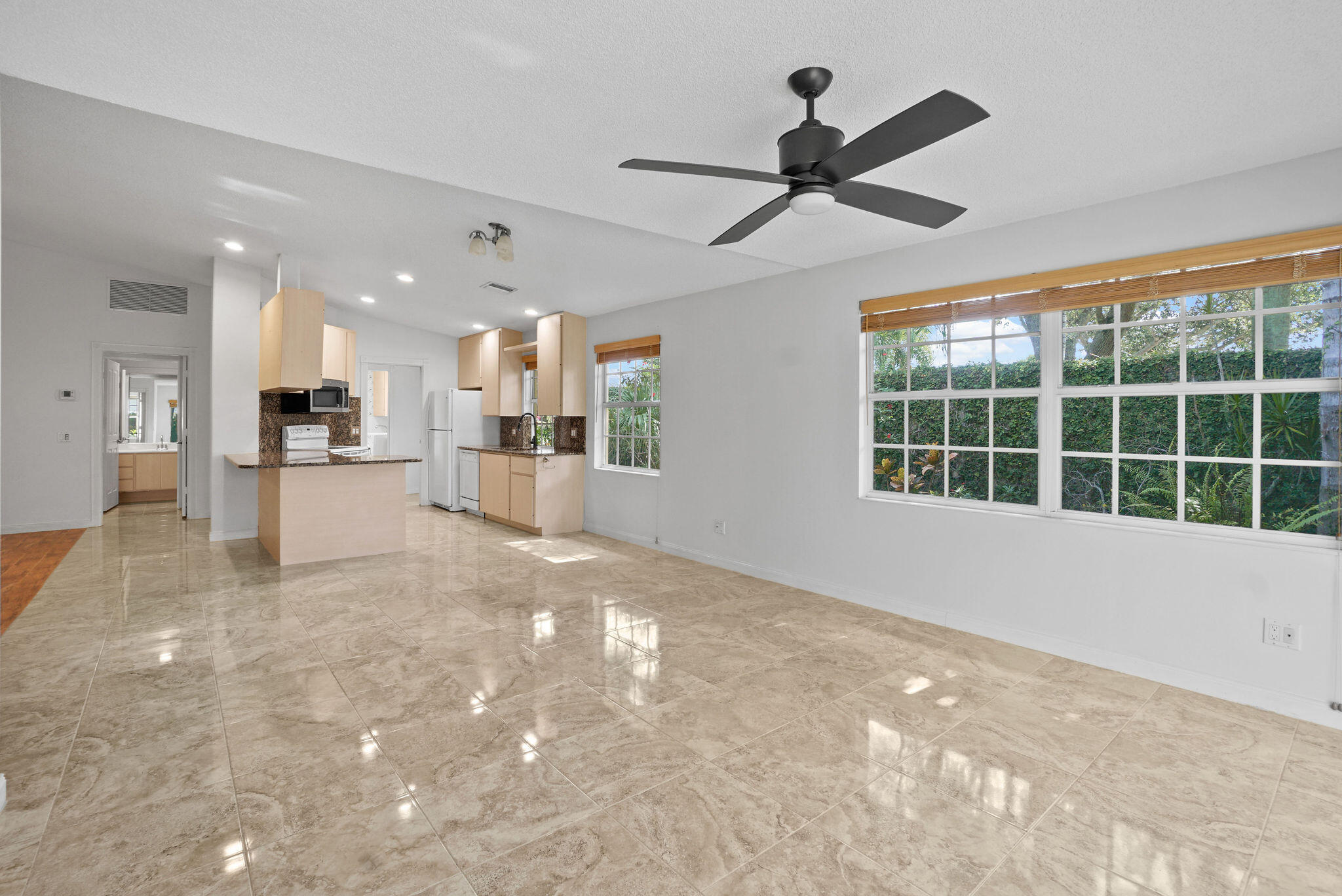 198 Brier Circle Jupiter, FL 33458 - Photo 13 of 38 a view of a kitchen with a sink and a window