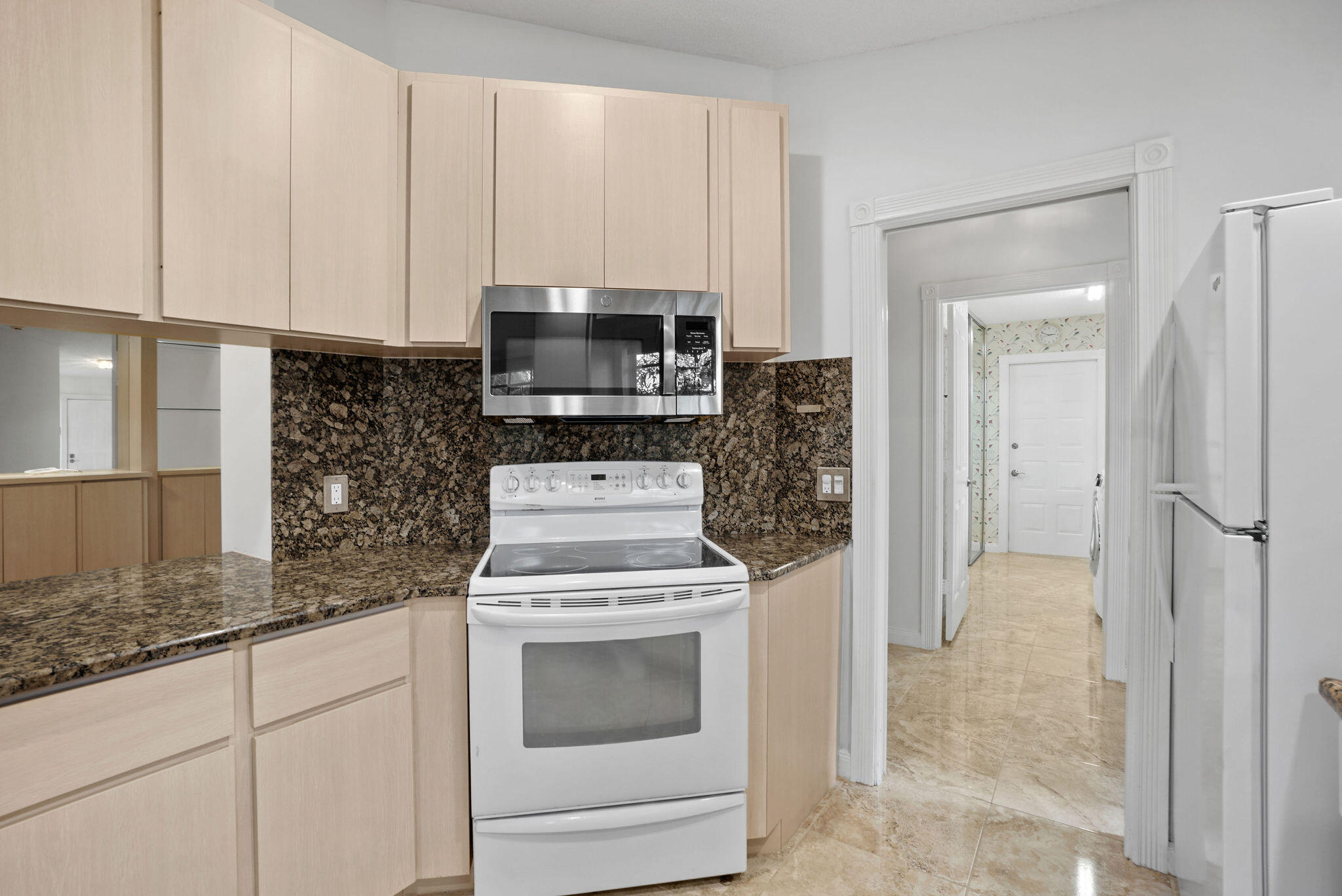 198 Brier Circle Jupiter, FL 33458 - Photo 18 of 38 a kitchen with stainless steel appliances granite countertop a stove a refrigerator and a microwave