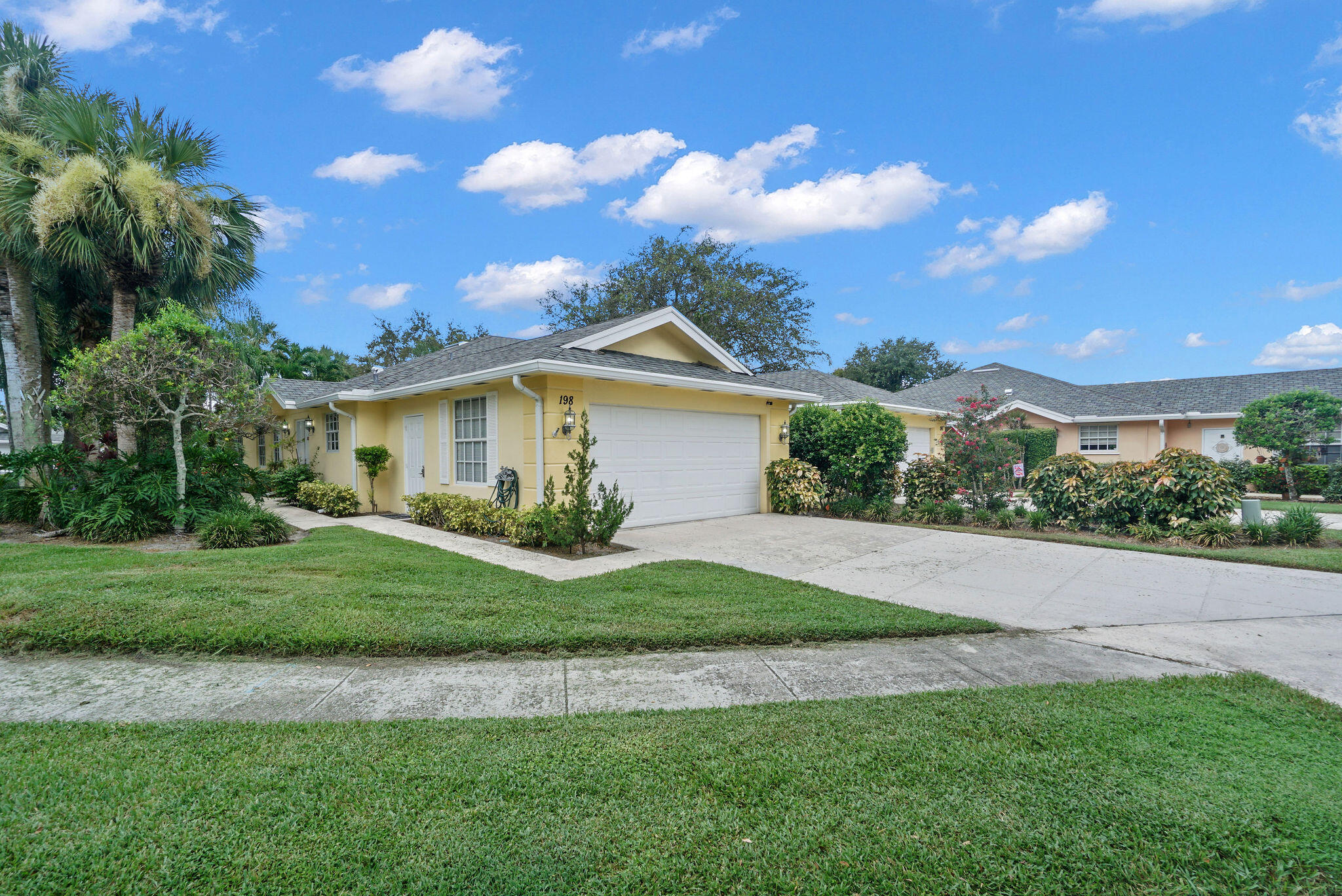 198 Brier Circle Jupiter, FL 33458 - Photo 2 of 38 a front view of a house with a garden