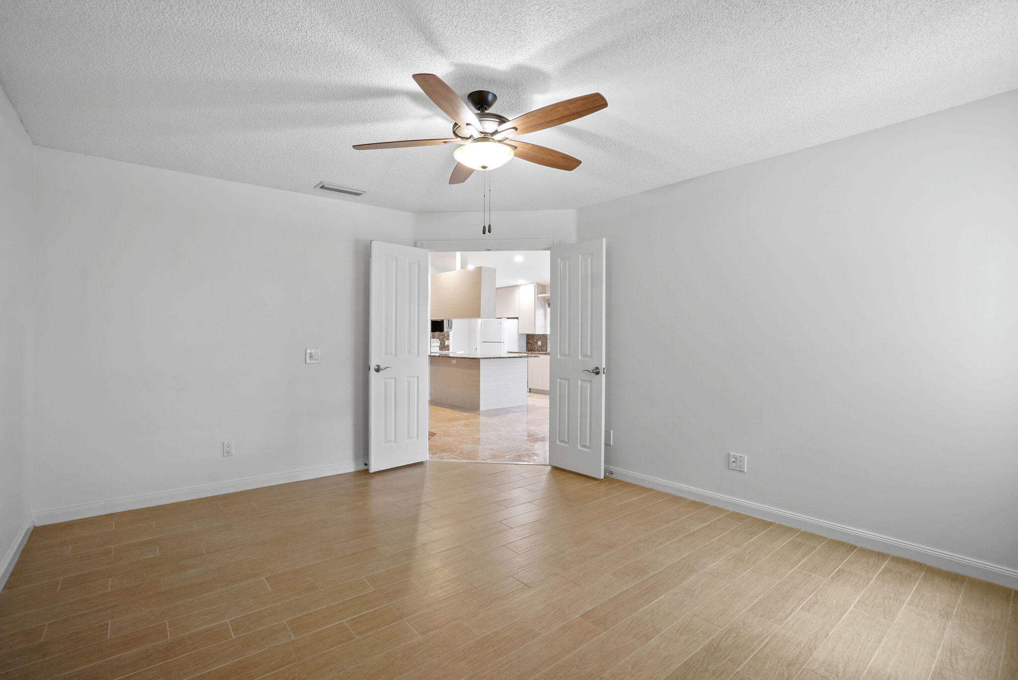 198 Brier Circle Jupiter, FL 33458 - Photo 22 of 38 a view of a livingroom with a ceiling fan and wooden floor