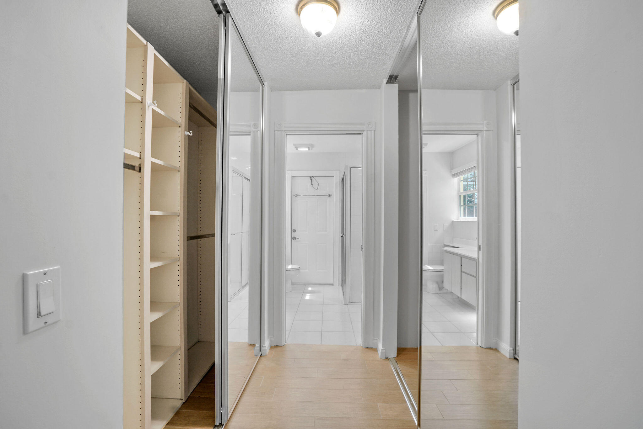 198 Brier Circle Jupiter, FL 33458 - Photo 24 of 38 a view of a hallway with wooden floor and a bathroom