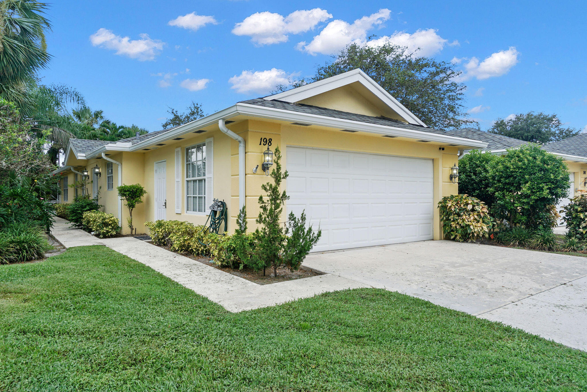 198 Brier Circle Jupiter, FL 33458 - Photo 4 of 38 a front view of a house with a garden