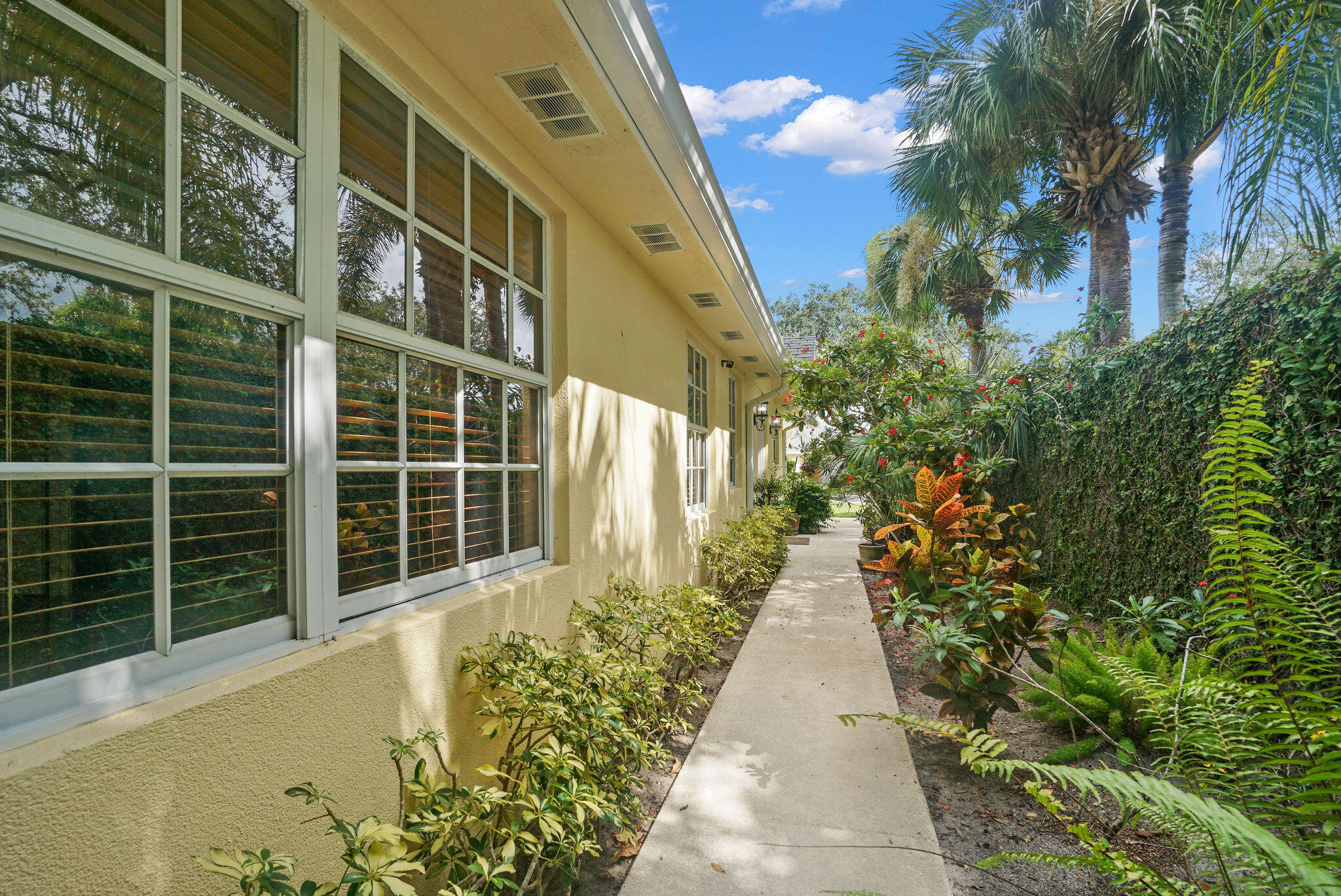 198 Brier Circle Jupiter, FL 33458 - Photo 6 of 38 a view of a pathway with a flower in front of a house