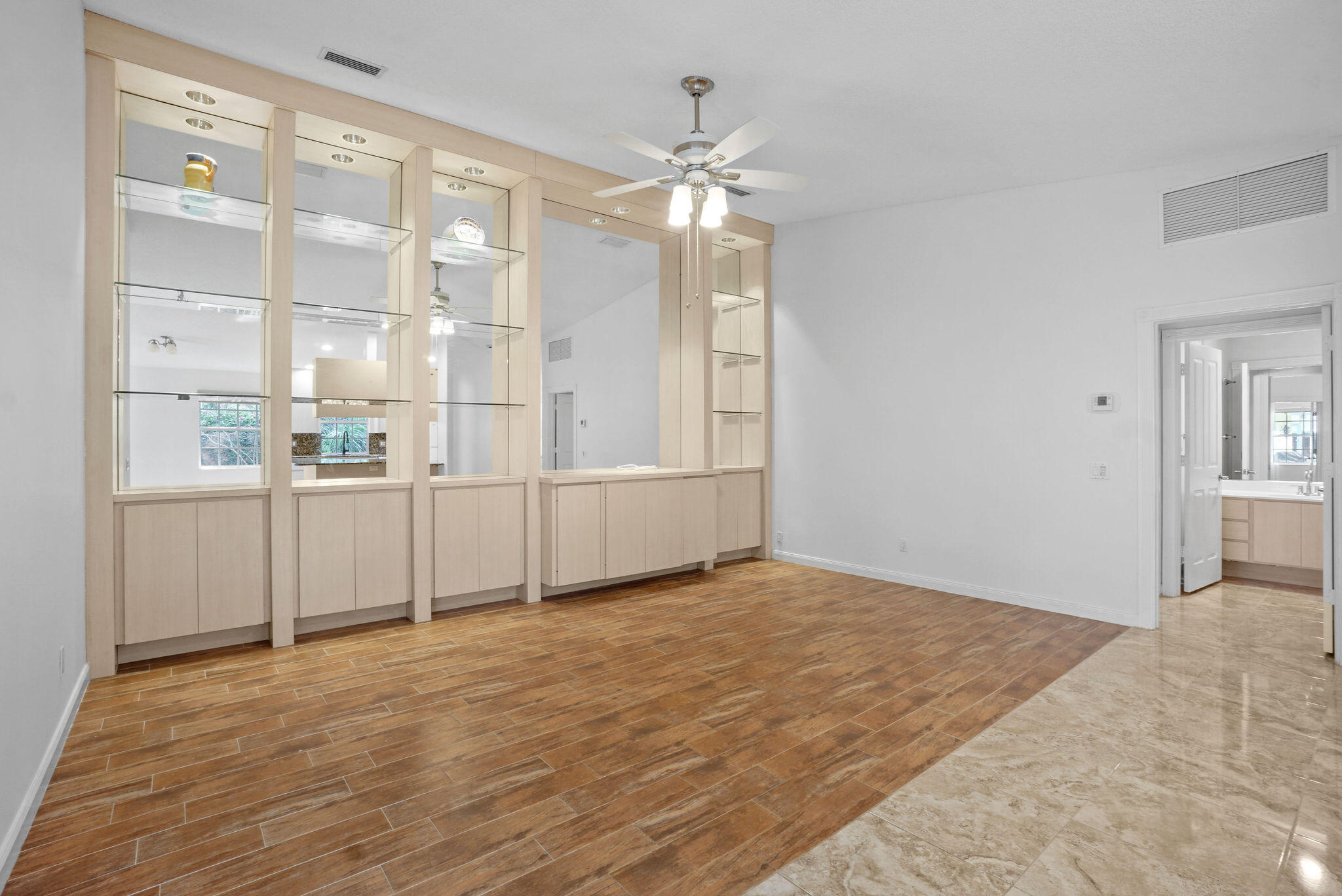 198 Brier Circle Jupiter, FL 33458 - Photo 10 of 38 a view of a livingroom with wooden floor and cabinet