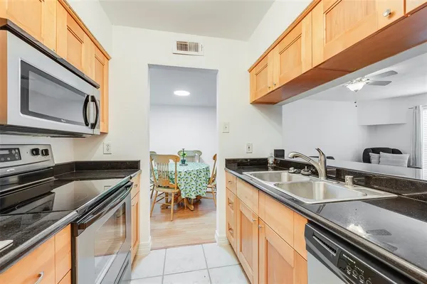 a kitchen with stainless steel appliances granite countertop a sink and stove