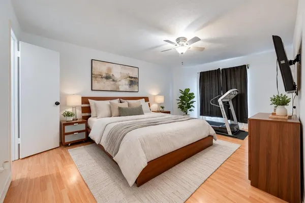 a bedroom with bed and window