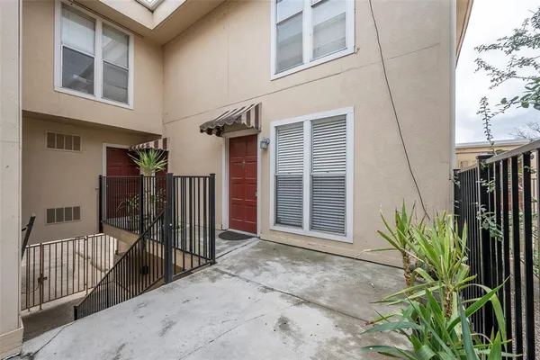 a view of a house with a plant in front of it