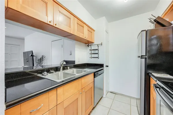 a kitchen with a sink and a refrigerator