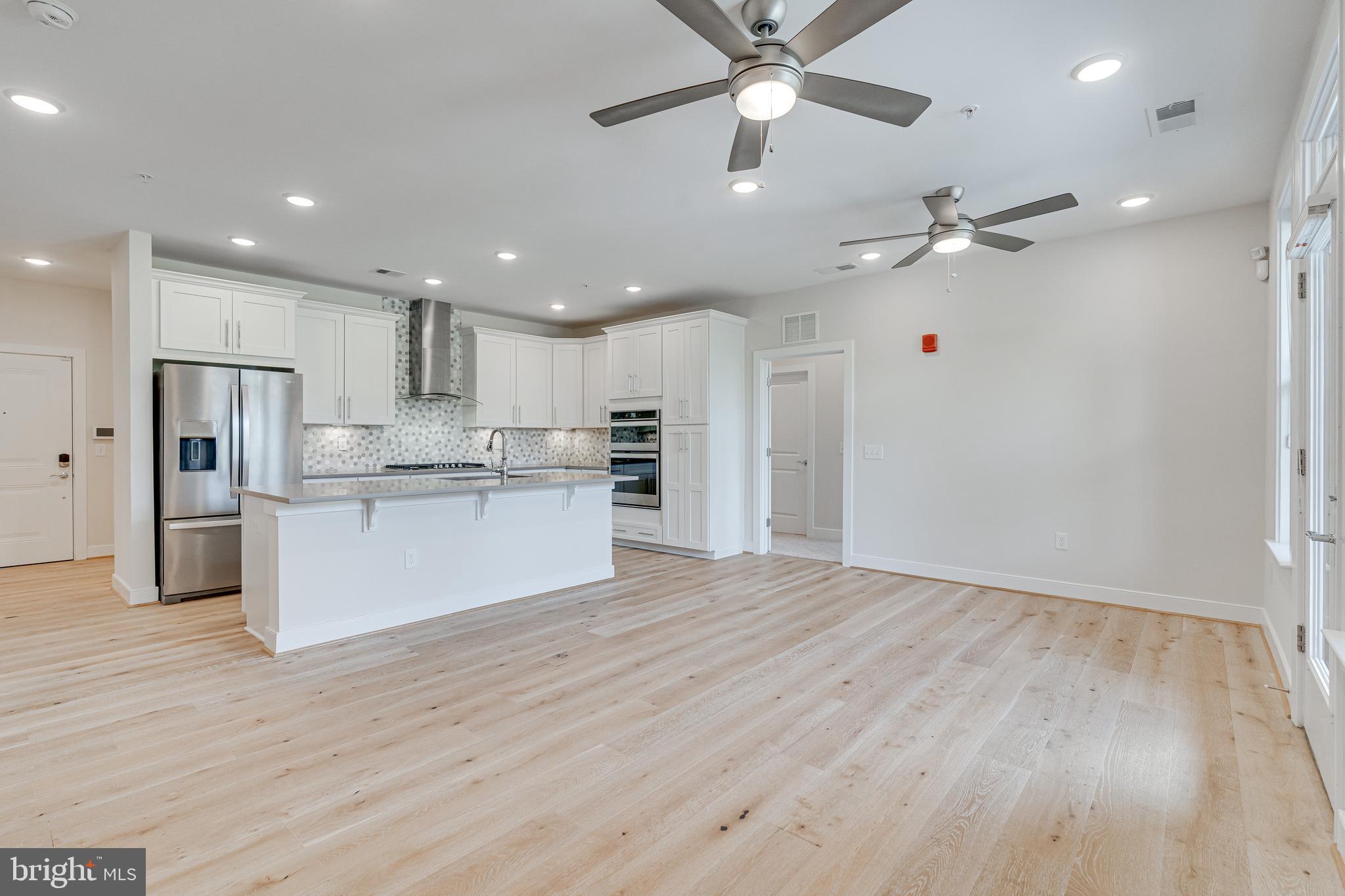 11200 Reston Station Boulevard, Unit 207 Reston, VA 20190 - Photo 11 of 40 a view of kitchen with cabinets appliances and wooden floor