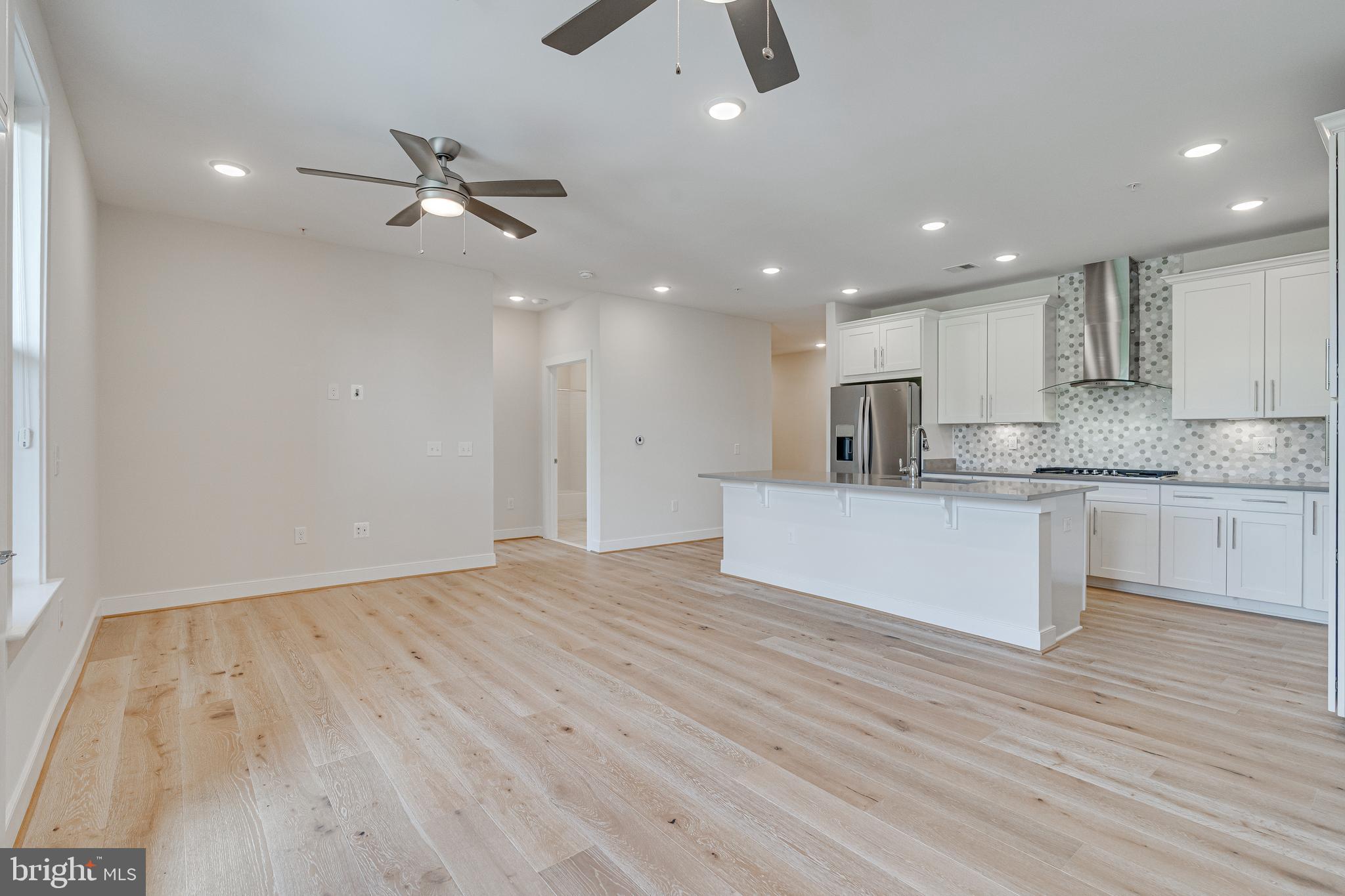 11200 Reston Station Boulevard, Unit 207 Reston, VA 20190 - Photo 40 of 40 a view of kitchen with kitchen island wooden floor center island and appliances