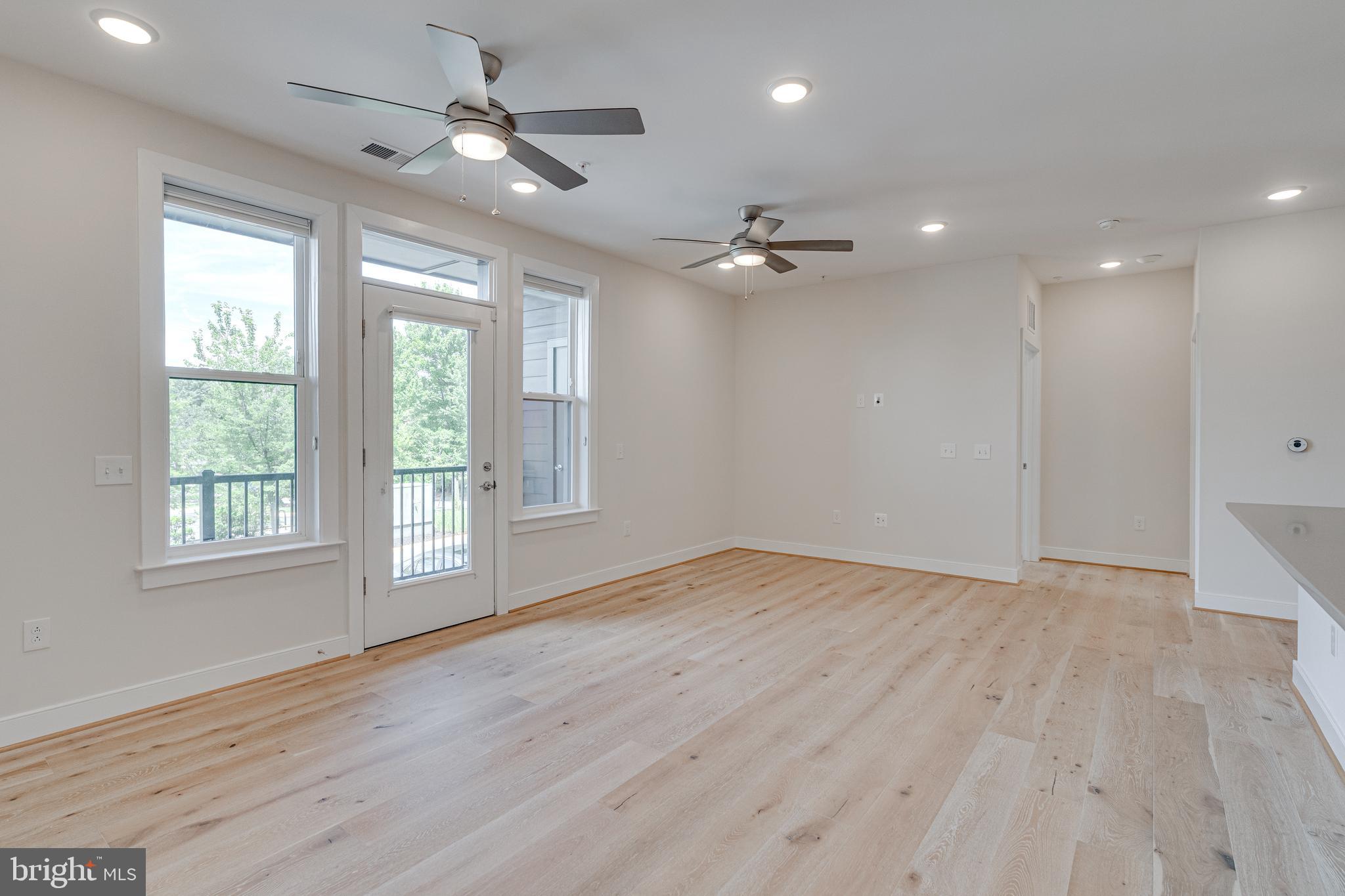 11200 Reston Station Boulevard, Unit 207 Reston, VA 20190 - Photo 12 of 40 a view of an empty room with a window and wooden floor