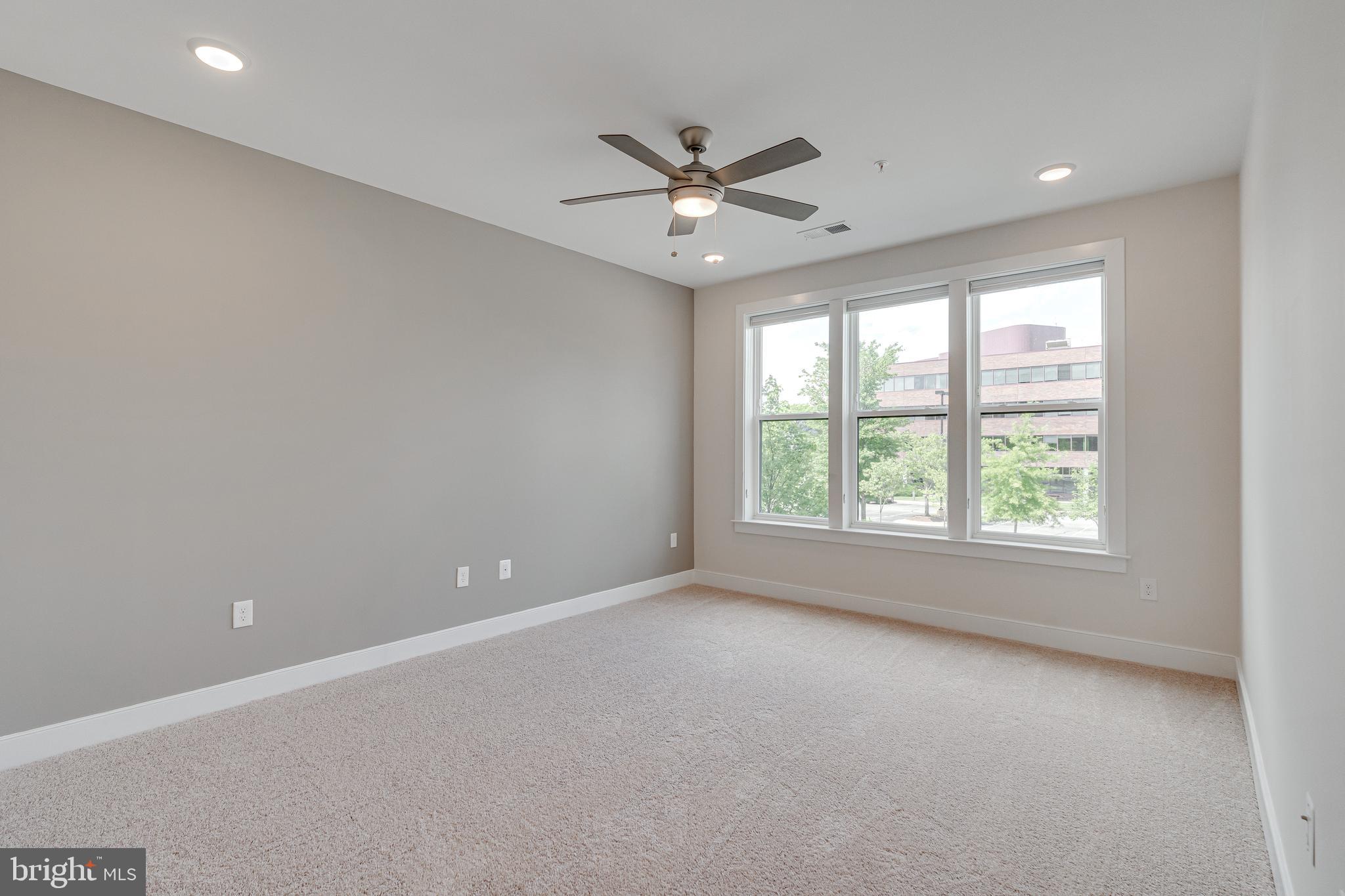 11200 Reston Station Boulevard, Unit 207 Reston, VA 20190 - Photo 13 of 40 an empty room with a window and a fan
