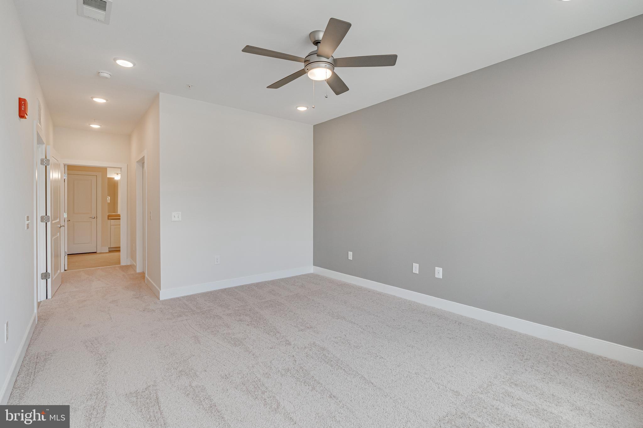 11200 Reston Station Boulevard, Unit 207 Reston, VA 20190 - Photo 14 of 40 an empty room with fan and a ceiling fan