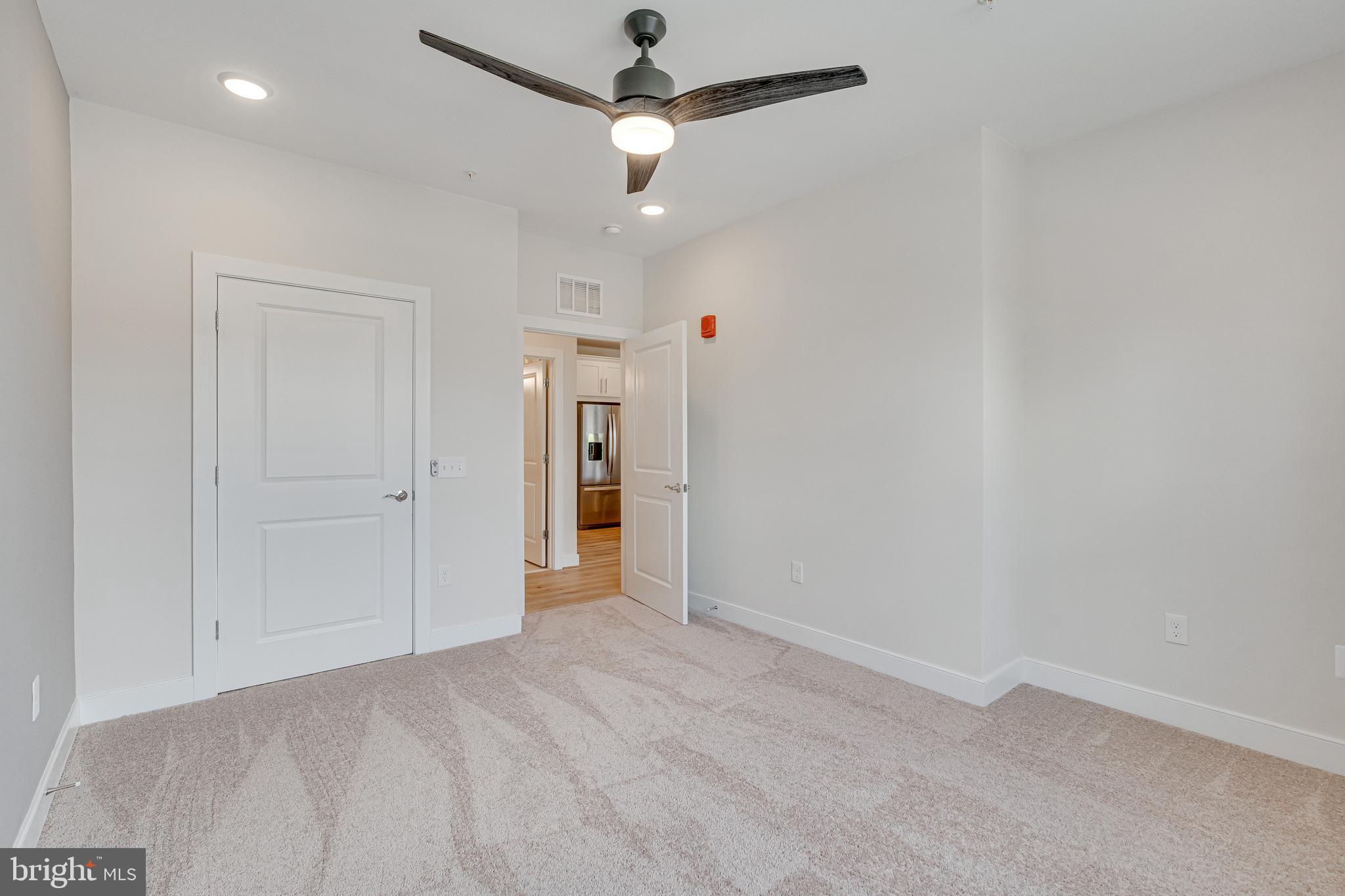 11200 Reston Station Boulevard, Unit 207 Reston, VA 20190 - Photo 20 of 40 an empty room with closet and a ceiling fan