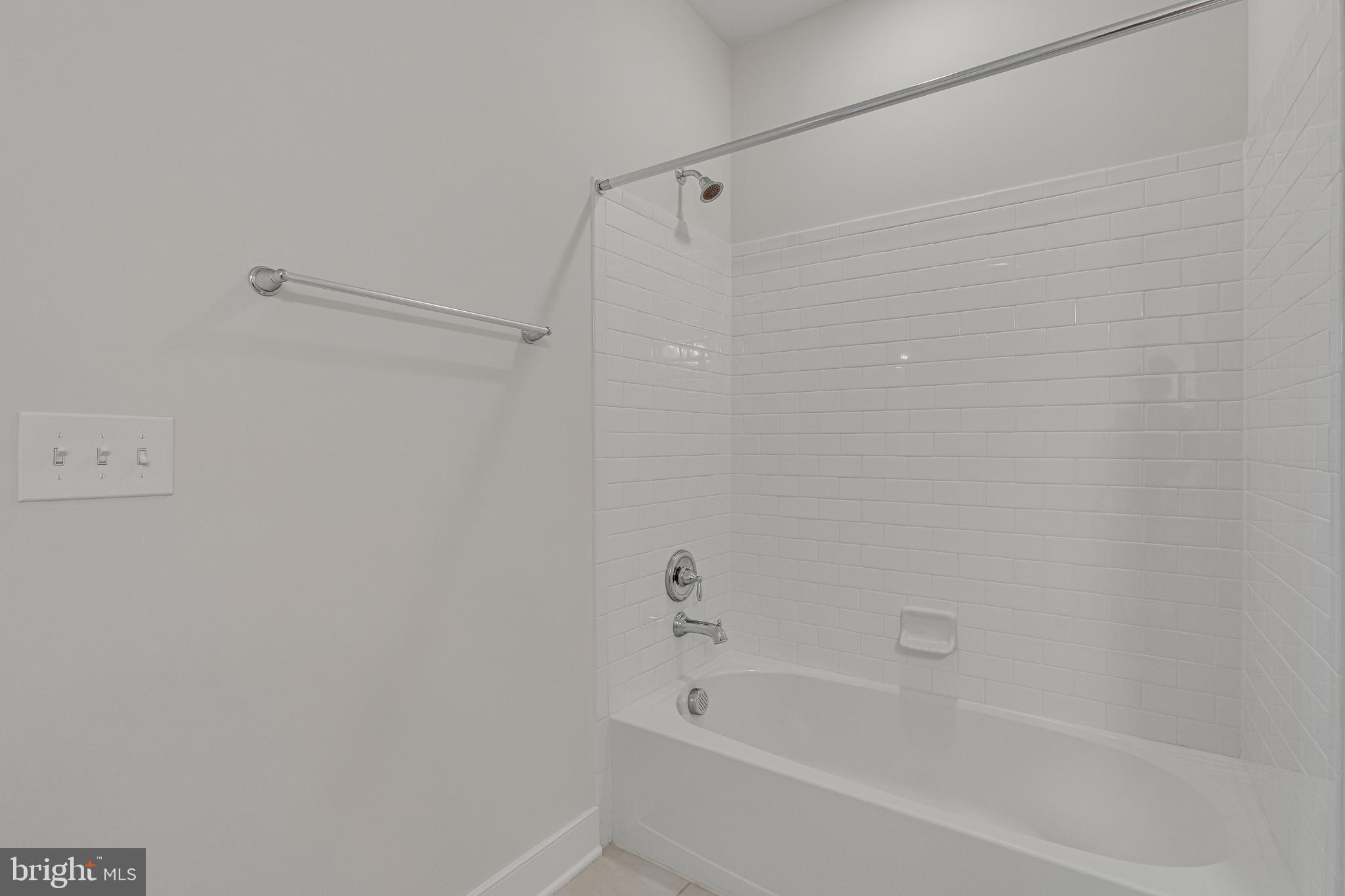 11200 Reston Station Boulevard, Unit 207 Reston, VA 20190 - Photo 23 of 40 a bathroom with a bathtub
