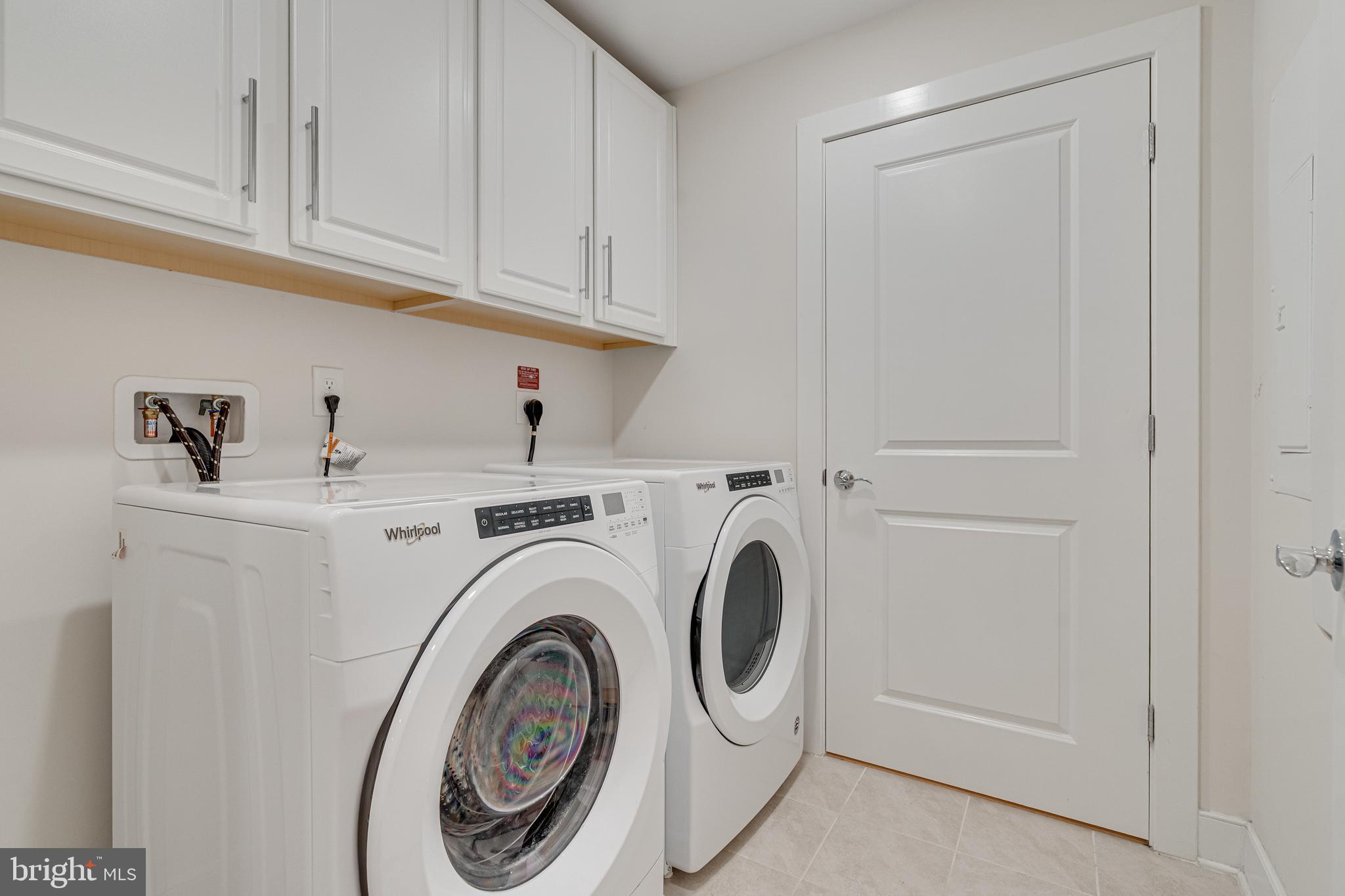 11200 Reston Station Boulevard, Unit 207 Reston, VA 20190 - Photo 26 of 40 a utility room with dryer and washer