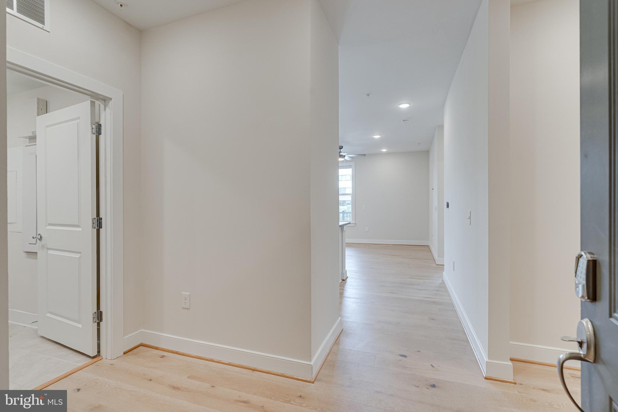 11200 Reston Station Boulevard, Unit 207 Reston, VA 20190 - Photo 3 of 40 a view of a hallway with wooden floor