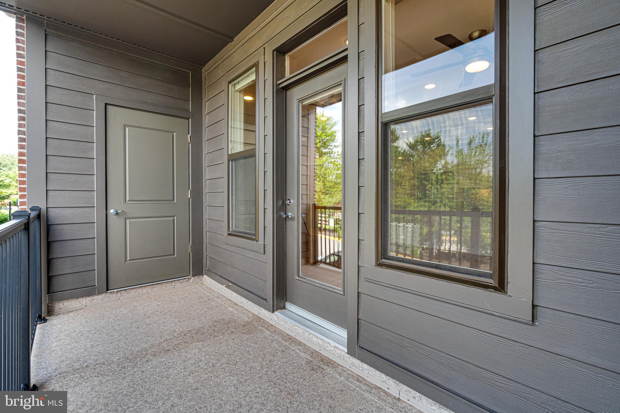 11200 Reston Station Boulevard, Unit 207 Reston, VA 20190 - Photo 29 of 40 a bedroom with a bed and a large window