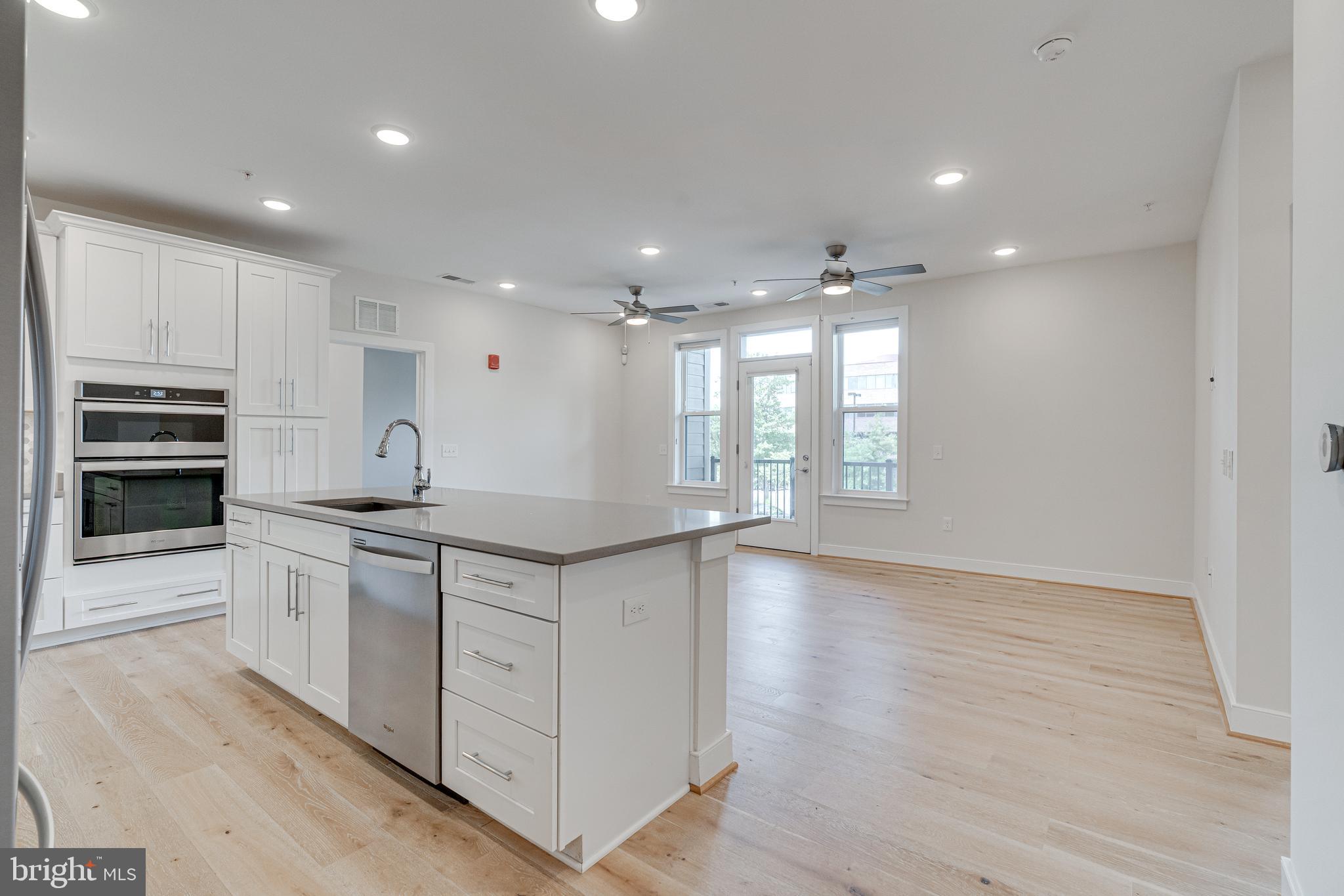 11200 Reston Station Boulevard, Unit 207 Reston, VA 20190 - Photo 39 of 40 a large kitchen with stainless steel appliances granite countertop a large counter top and a stove top oven