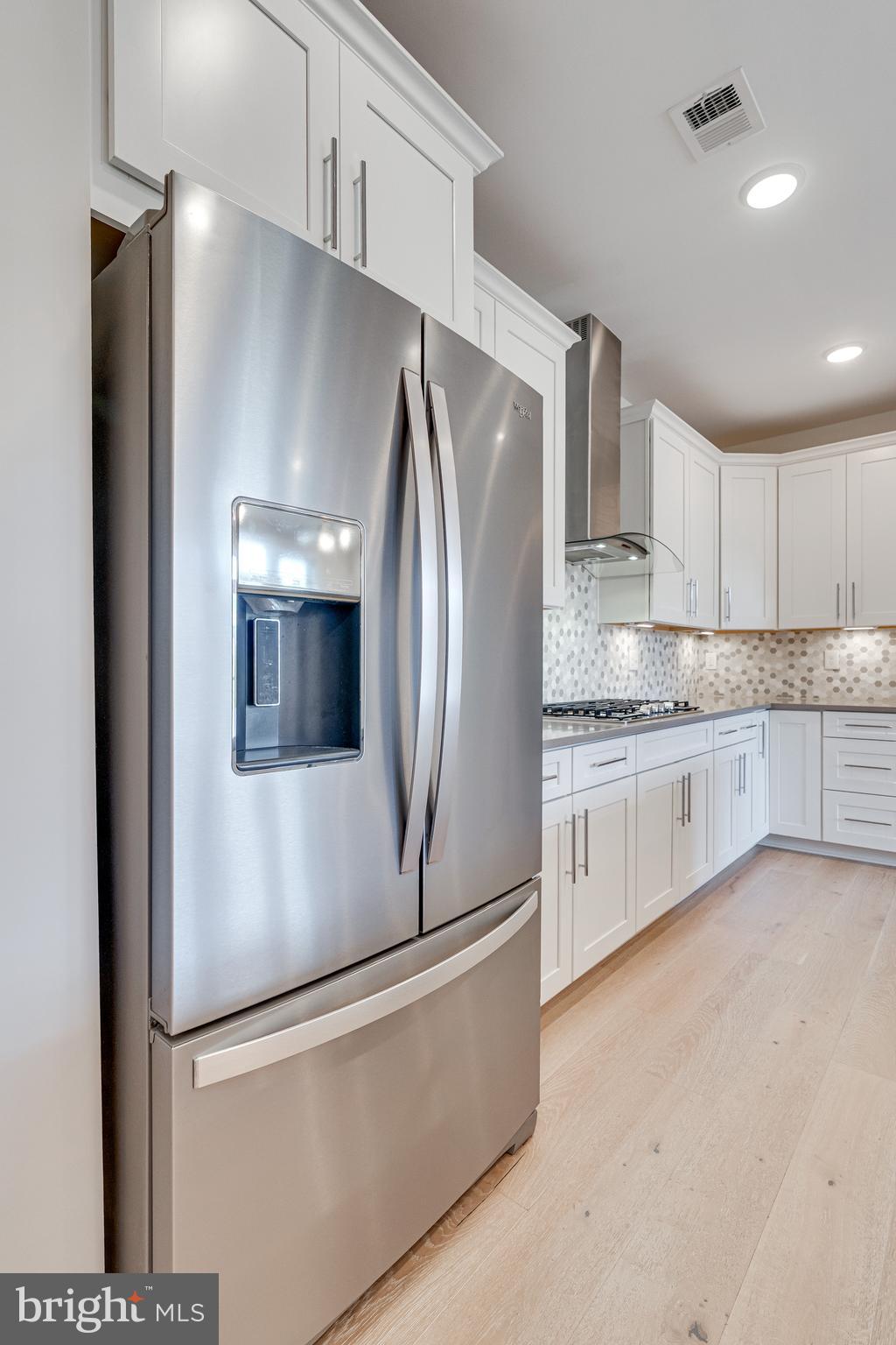 11200 Reston Station Boulevard, Unit 207 Reston, VA 20190 - Photo 8 of 40 a kitchen with stainless steel appliances a refrigerator and a stove top oven