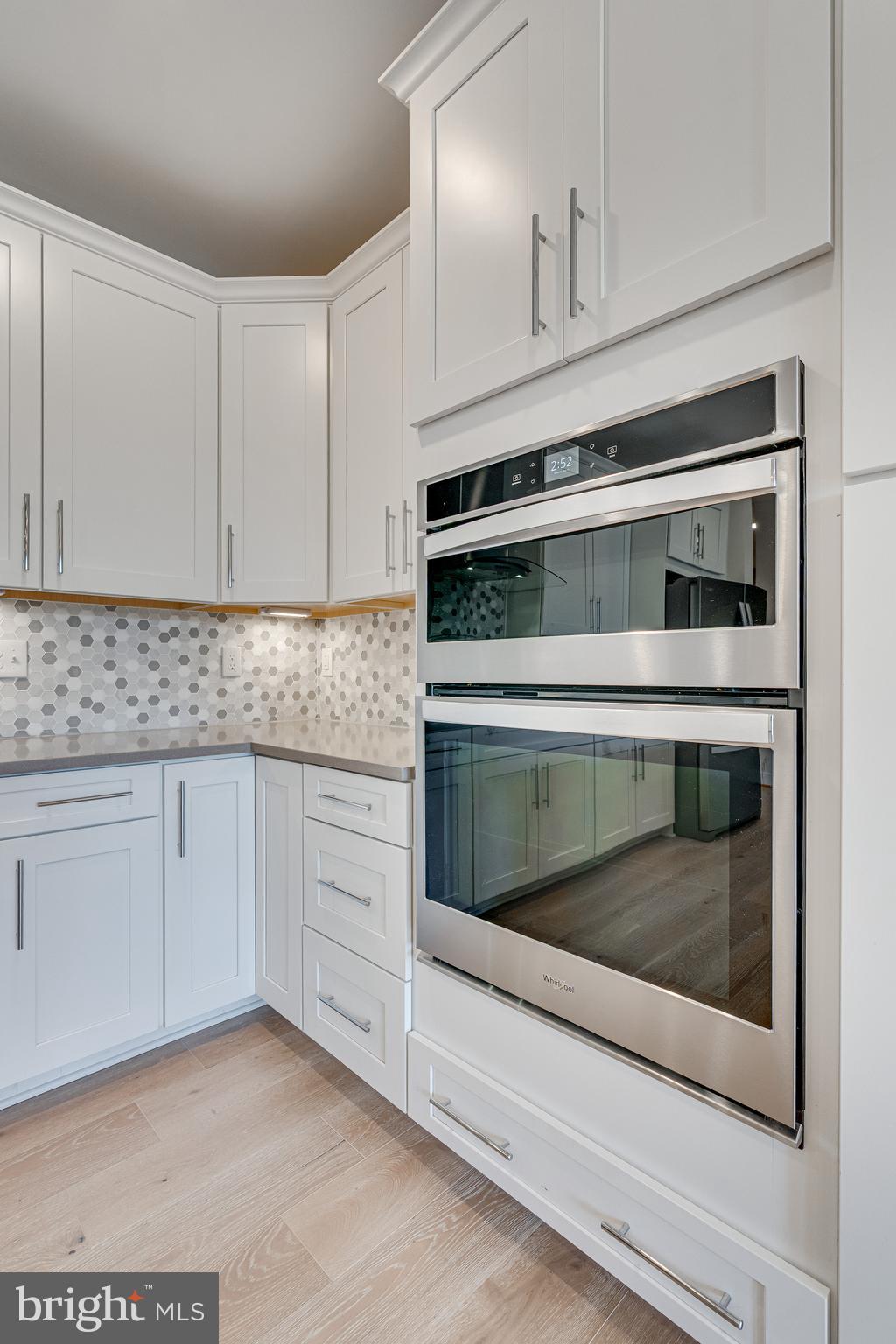 11200 Reston Station Boulevard, Unit 207 Reston, VA 20190 - Photo 9 of 40 a kitchen with granite countertop white cabinets stainless steel appliances and a sink
