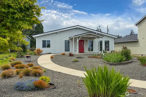 a view of a house with a backyard and plants