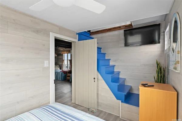 a view of a livingroom with wooden floor and stairs