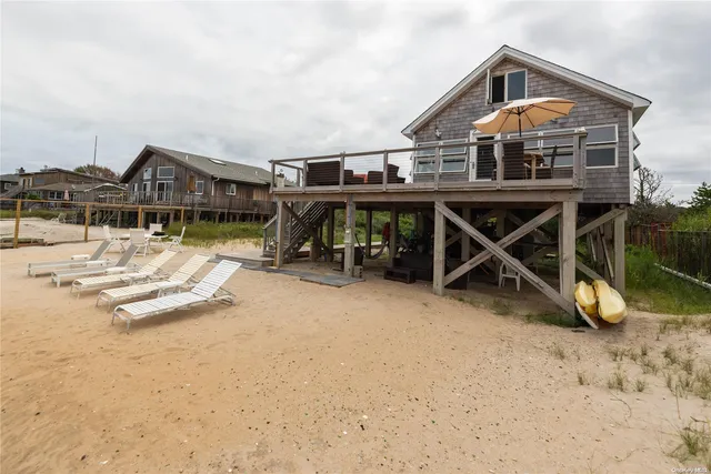 a view of a house with a swimming pool and sitting area