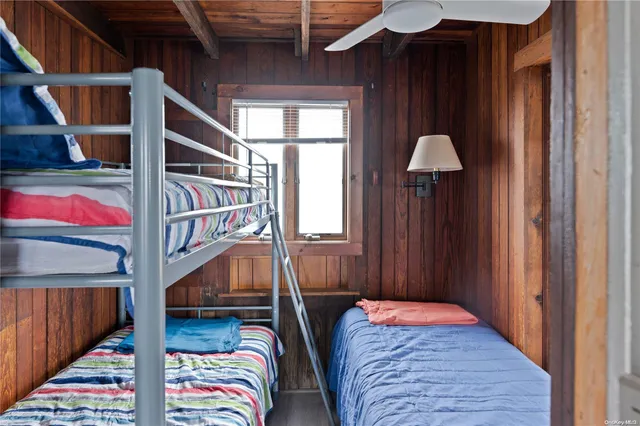 a bedroom with bunk bed and a window