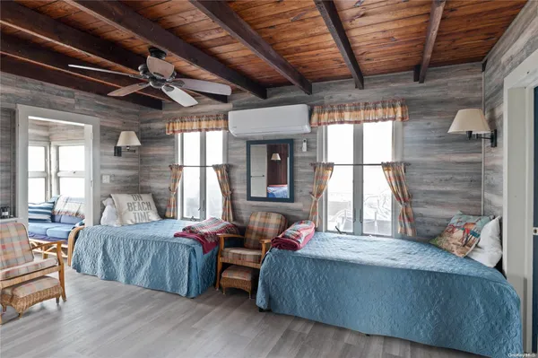 a bedroom with furniture and a large window