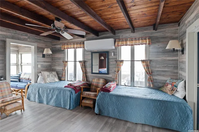 a bedroom with furniture and a large window