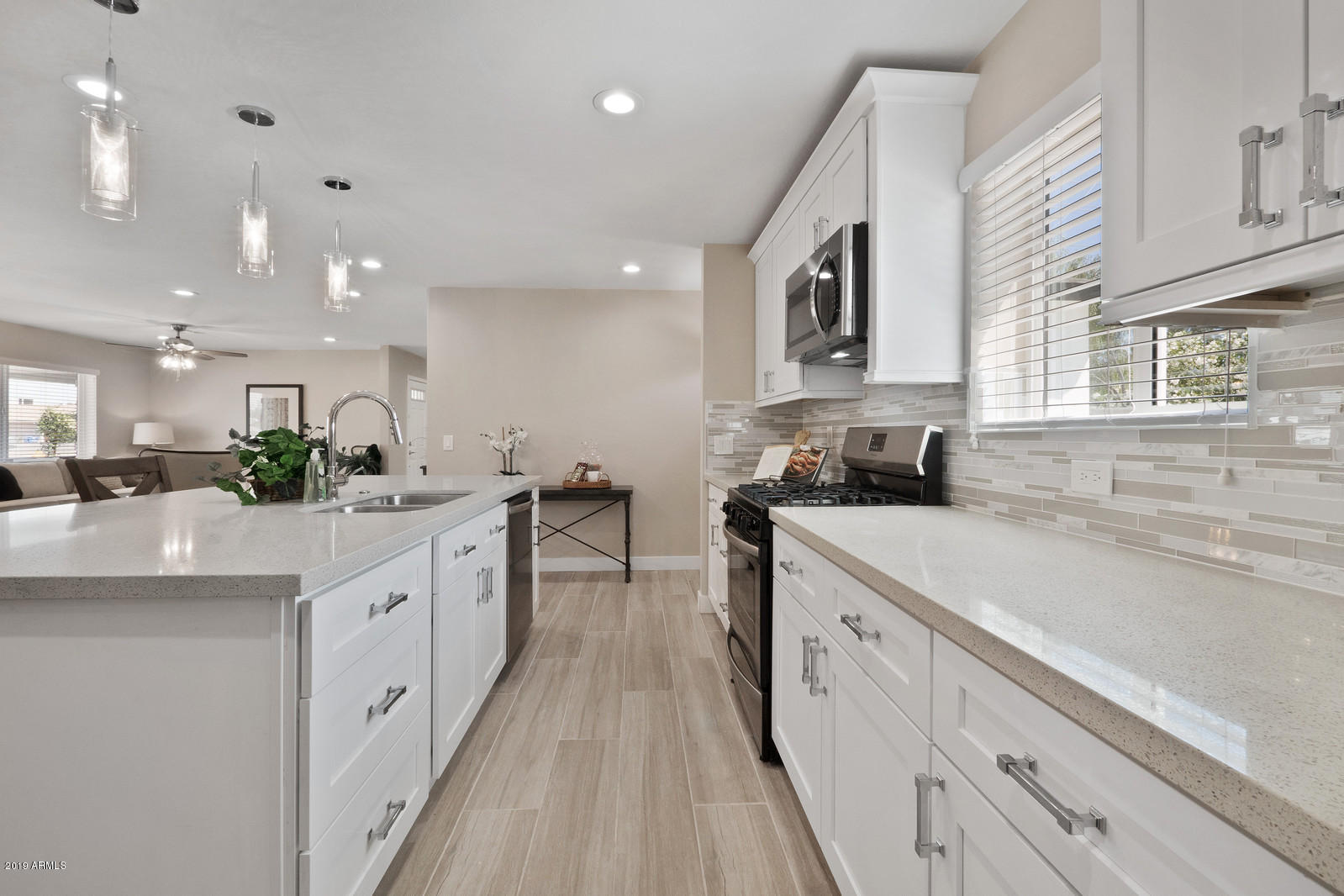 3351 North Randolph Road Phoenix, AZ 85014 - Photo 12 of 47 a kitchen with white cabinets and white appliances