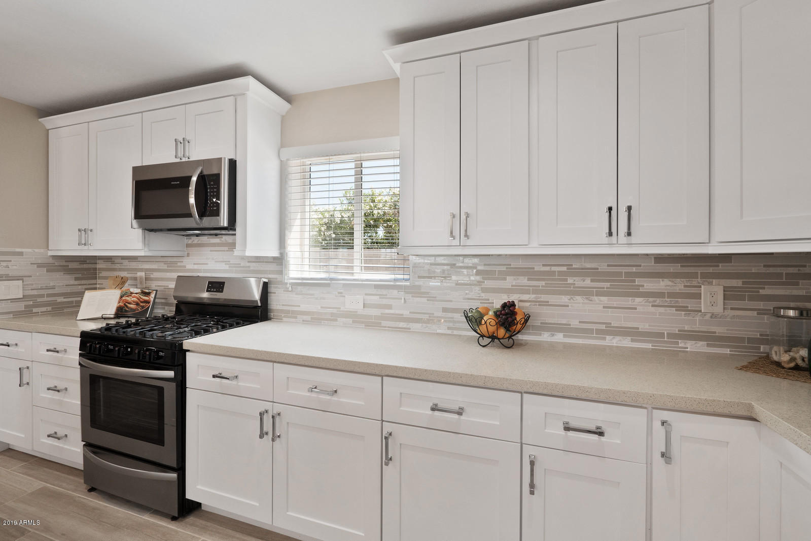 3351 North Randolph Road Phoenix, AZ 85014 - Photo 14 of 47 a kitchen with white cabinets stainless steel appliances and sink