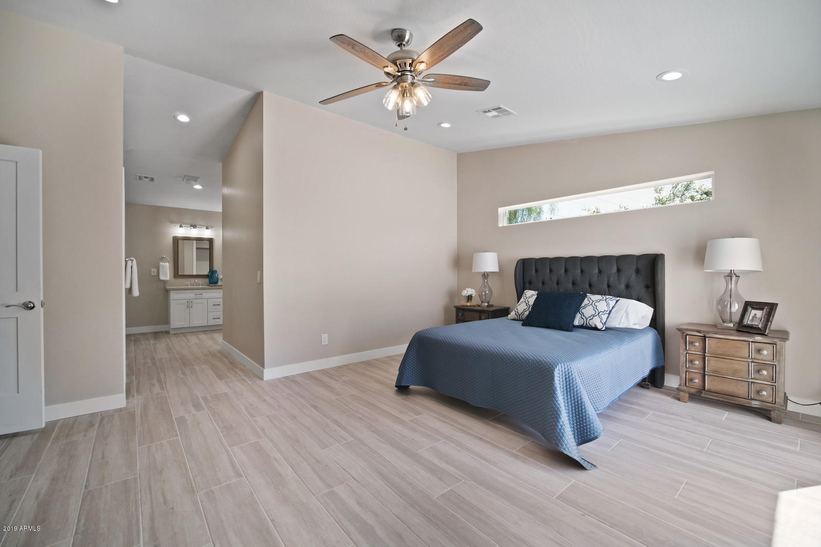 3351 North Randolph Road Phoenix, AZ 85014 - Photo 18 of 47 a spacious bedroom with a bed and a chandelier
