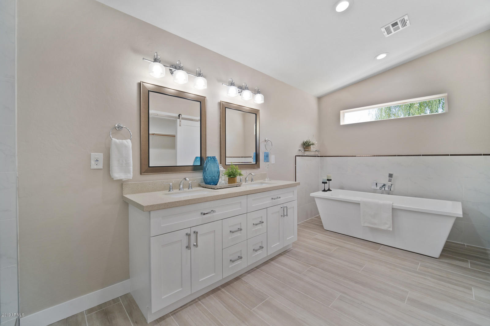 3351 North Randolph Road Phoenix, AZ 85014 - Photo 19 of 47 a spacious bathroom with a double vanity sink and a mirror