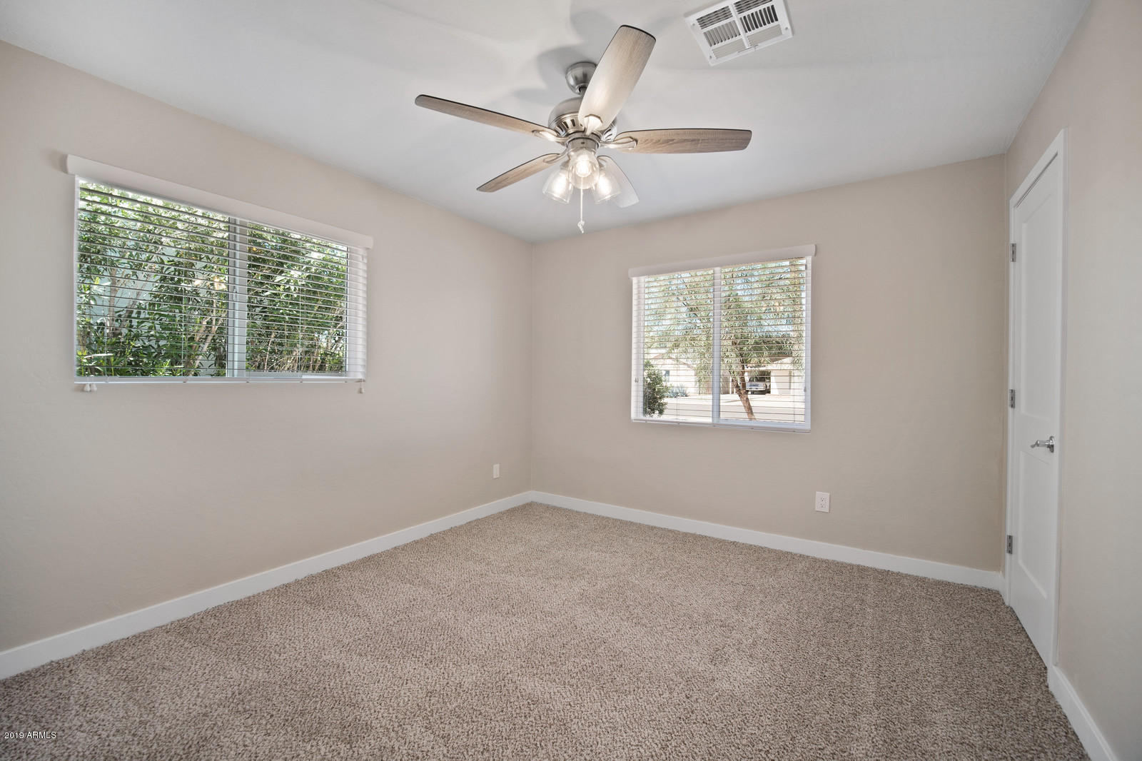 3351 North Randolph Road Phoenix, AZ 85014 - Photo 26 of 47 an empty room with windows and fan
